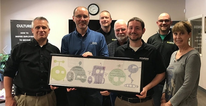EZ Micro Employees holding the framed Phrase Art in EZ Micro bots