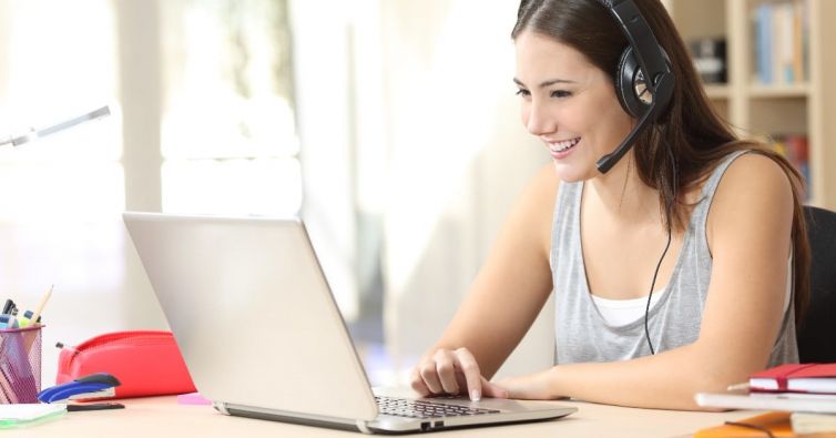 EZ Micro Solutions: Woman sitting in front of laptop with headset